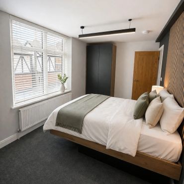 Modern bedroom with a comfortable bed and minimalist decor.