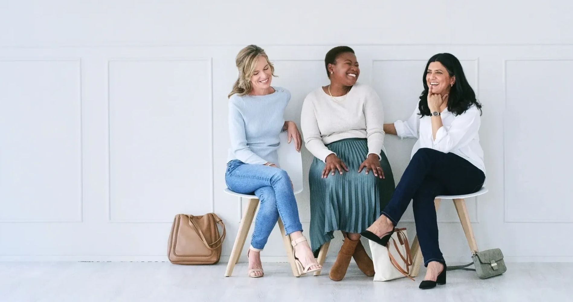 Three professional women sitting together, representing friendship and social connection