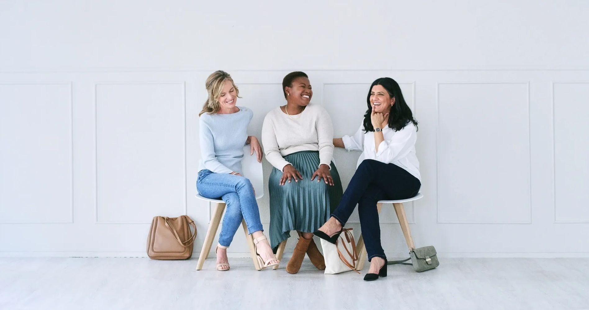 Three professional women sitting together, representing friendship and social connection