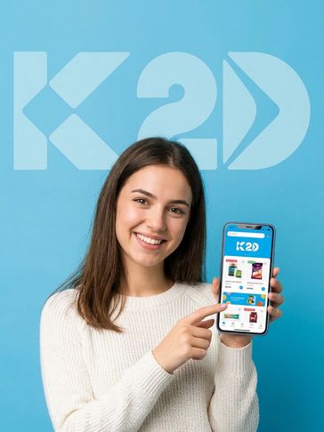 Young woman smiling and holding a phone with the K2D app.
