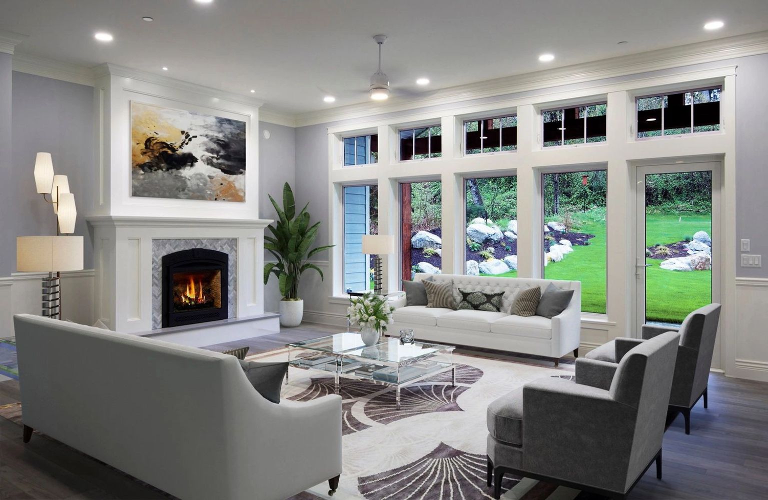 Bright living room with large windows, a fireplace, and modern furniture.
