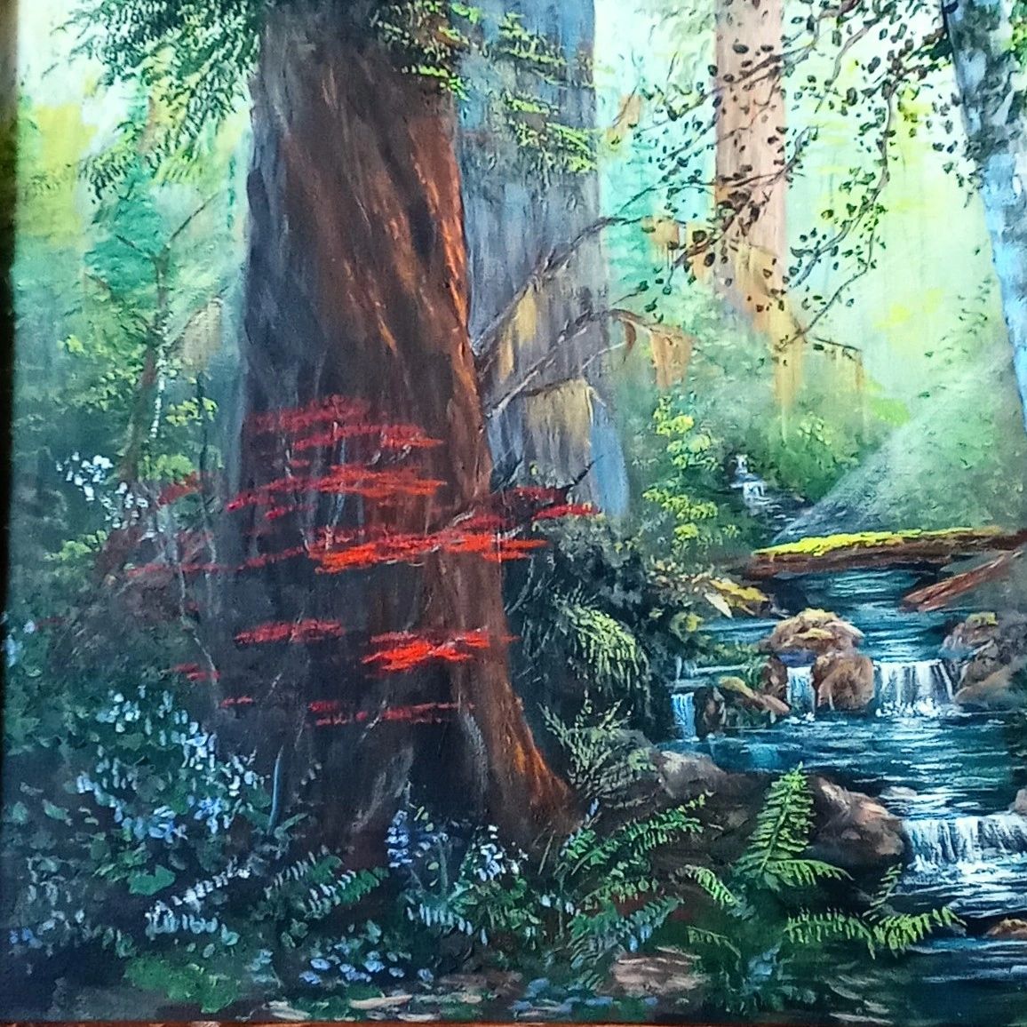 A serene forest scene with a flowing stream and vibrant foliage.