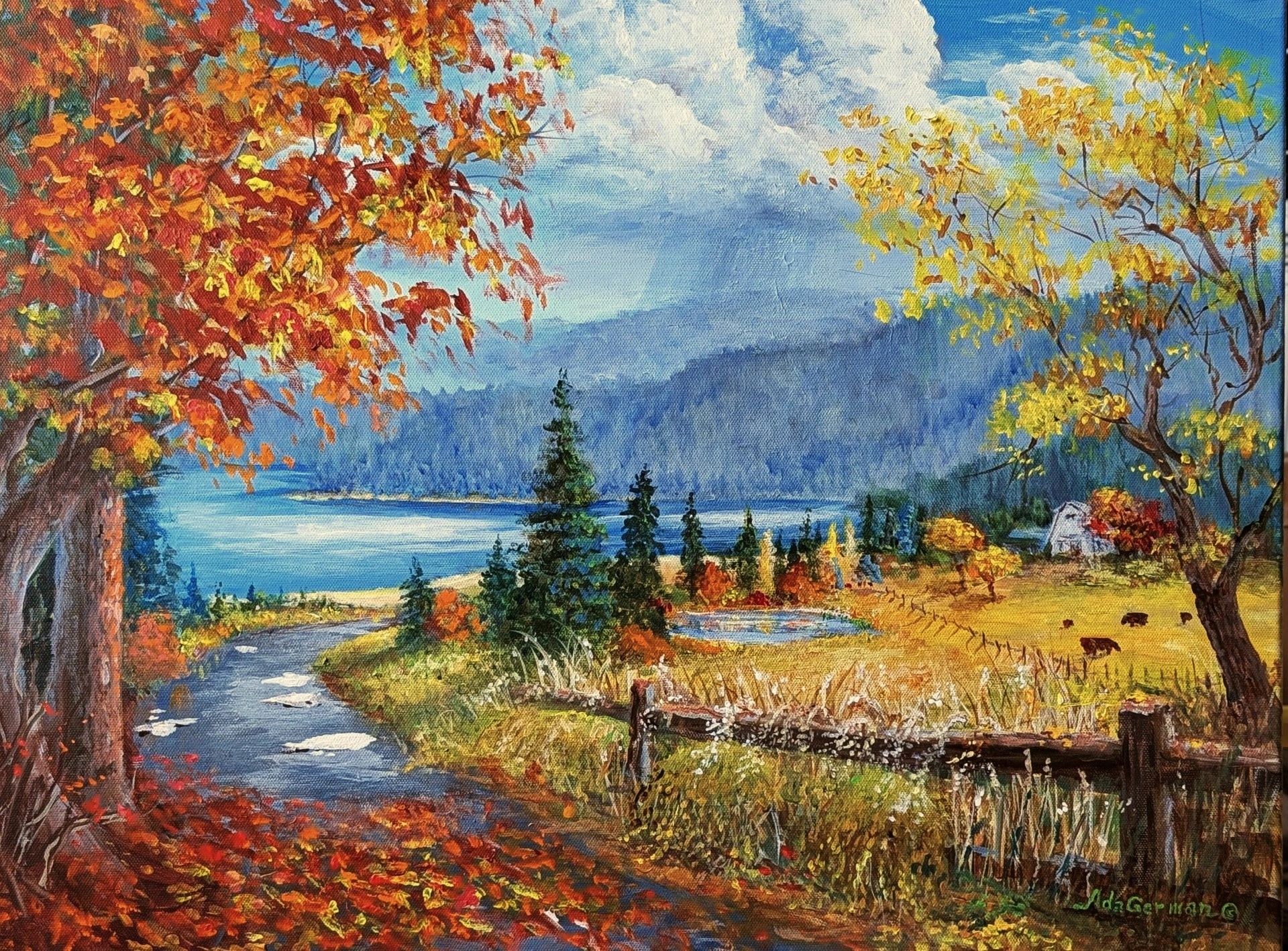 Autumn landscape with colorful trees, a winding path, and a lake under a cloudy sky.