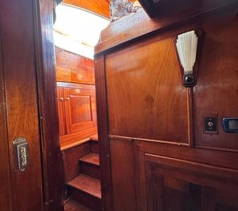 Wood-paneled interior with steps leading to a small cabin space.