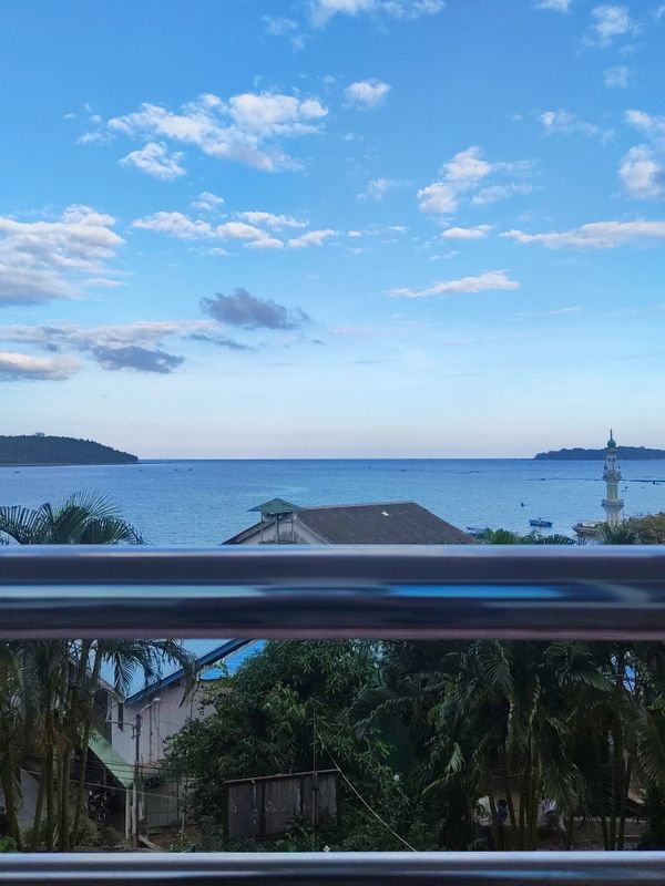 Scenic ocean view with clear sky and distant islands.