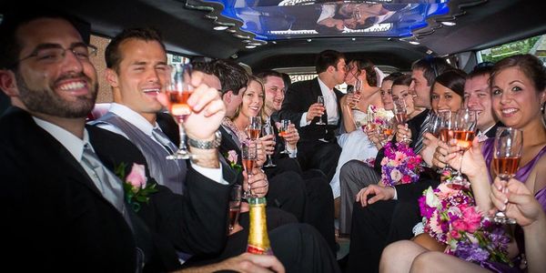 People having a fantastic time inside the Cadillac Escalade limousine