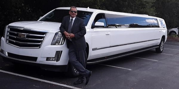 Stretched white Cadillac Escalade limousine with luscious interior
