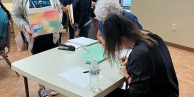 A woman sitting in a chair and studying at a table