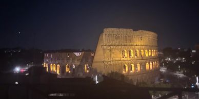 Colosseum illuminated at night in Rome.