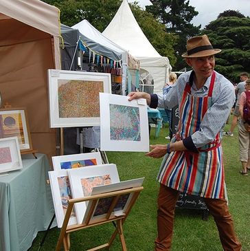 Abstract Artist Max Kaiser at Art in the Park presenting his work to the collectors and the public.