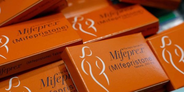 Boxes of Mifeprex (Mifepristone) tablets in orange packaging.