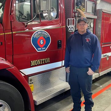 Fire Chief Andy Lee in front of a fire engine