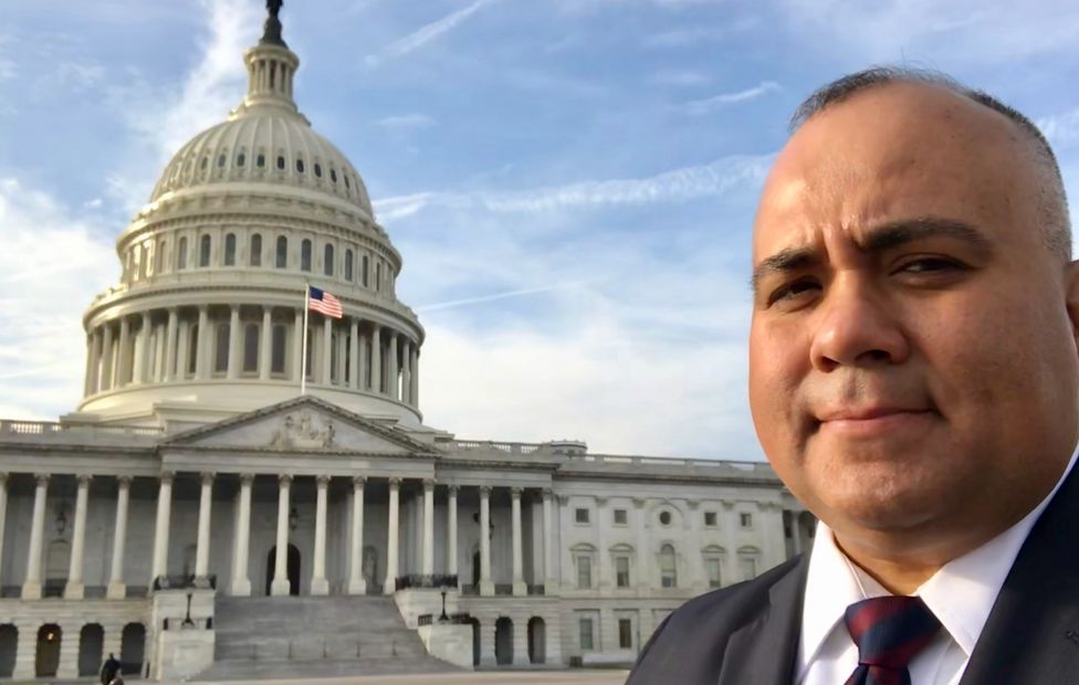 Host Jesse Garcia standing in front of the U.S. Capitol.