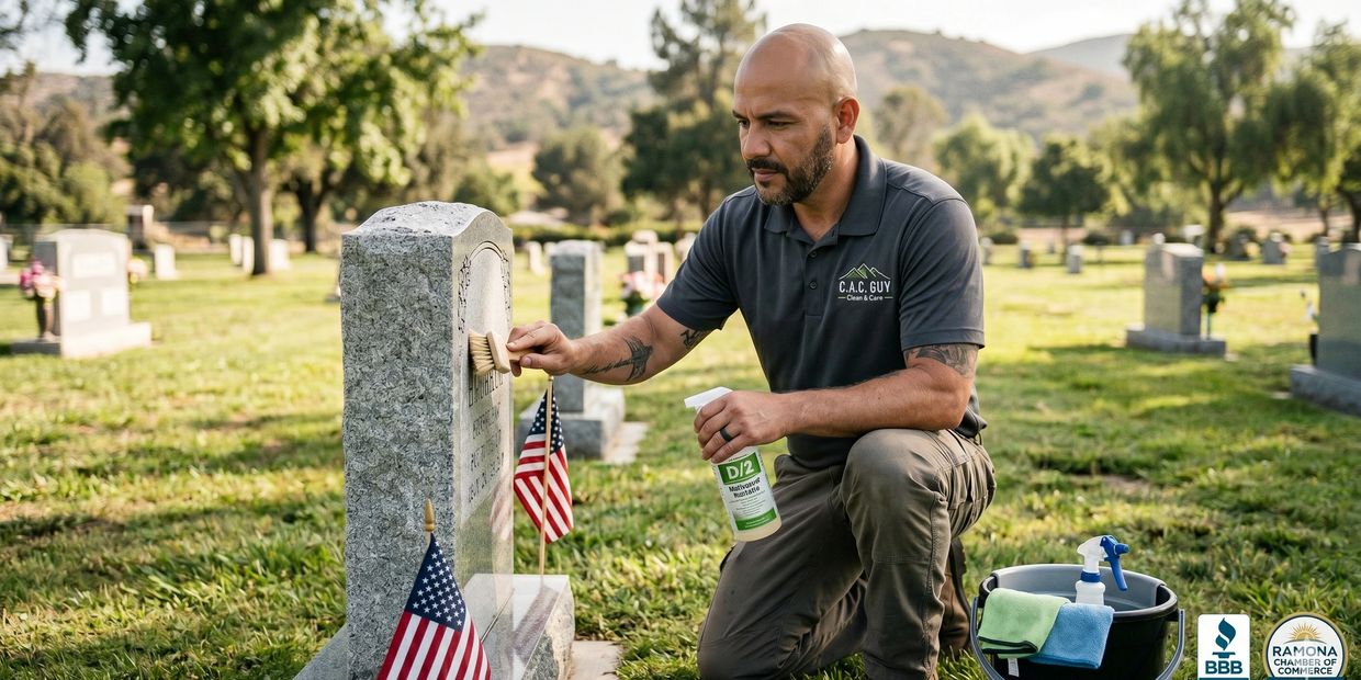 Man cleaning a gravestone with a brush and cleaning spray in a cemetery.
