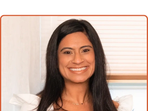 A smiling woman with long black hair.