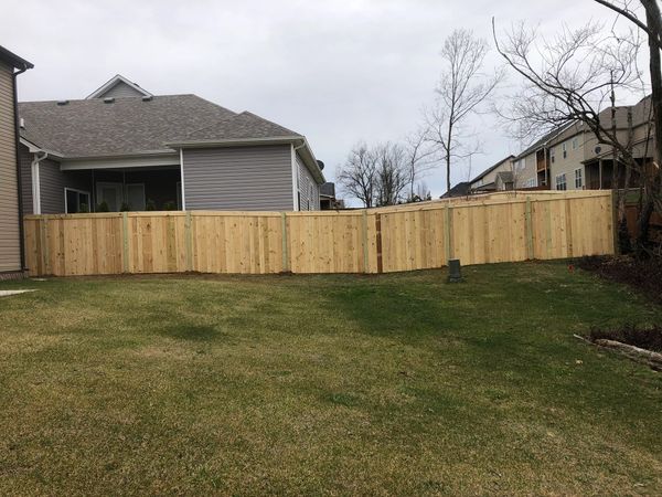 wood fence by tiger fencing with a top running board 