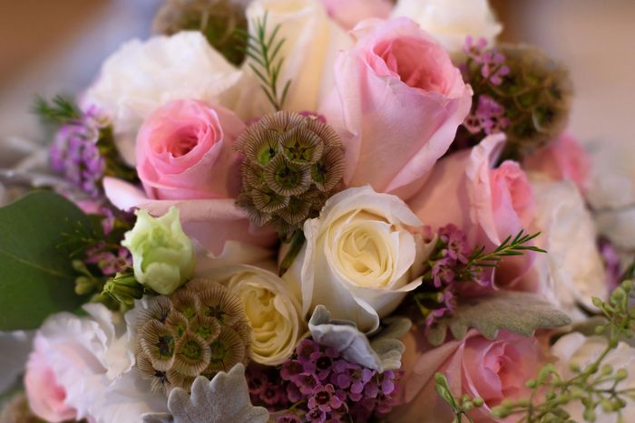 Elegant floral wedding decoration with roses and greenery.