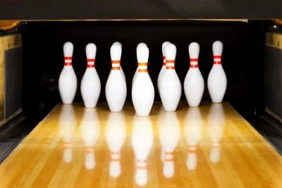 Seven bowling pins standing on a bowling lane.