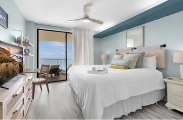 Bright bedroom with ocean view and modern decor.
