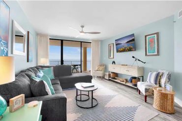 Bright living room with ocean view and modern decor.