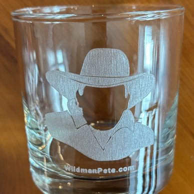 Clear glass with etched cowboy silhouette and website text.