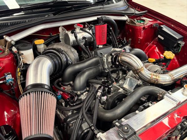 Close-up of a car engine with performance modifications.