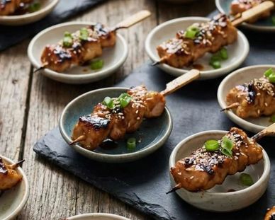 Grilled chicken skewers with sesame and scallions.