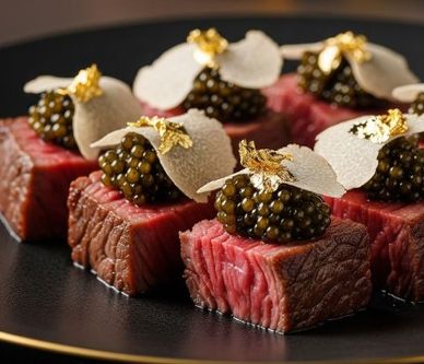 Gourmet beef cubes topped with caviar and gold leaf.
