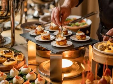 Plated appetizers being prepared and served.