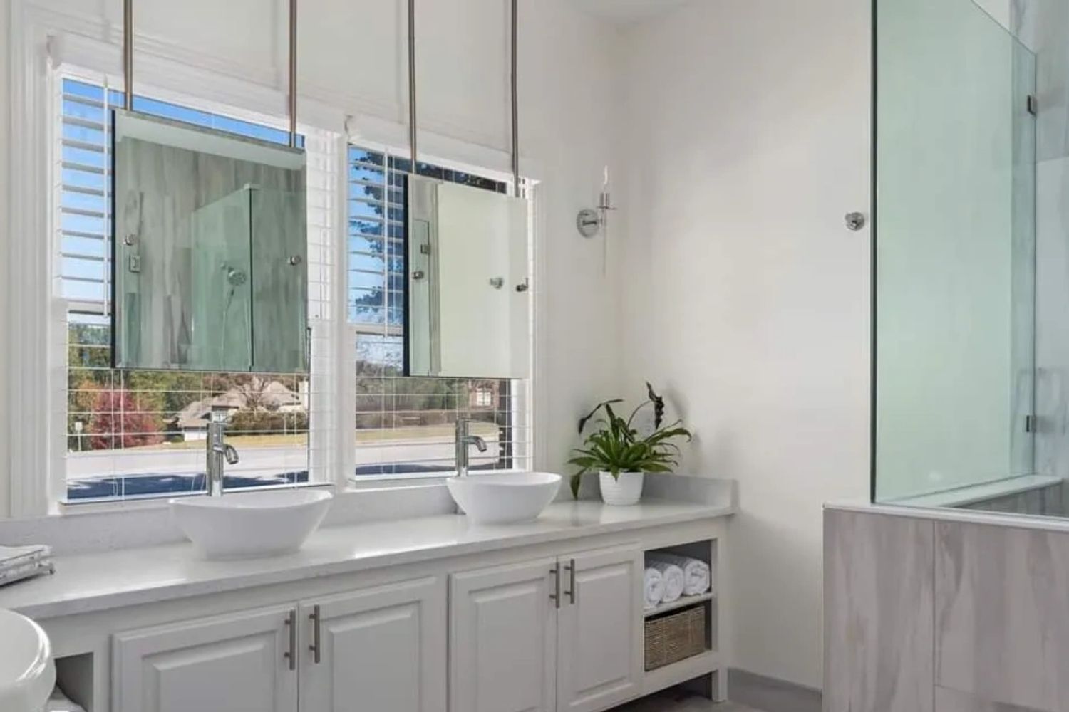 Custom bathroom with unique mirrors and  vessel sinks.
