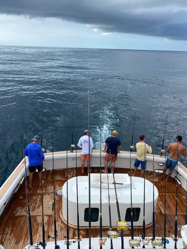 men fishing on yacht