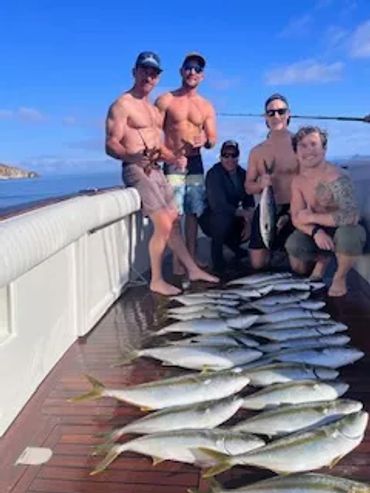 men sportfishing with fish on deck