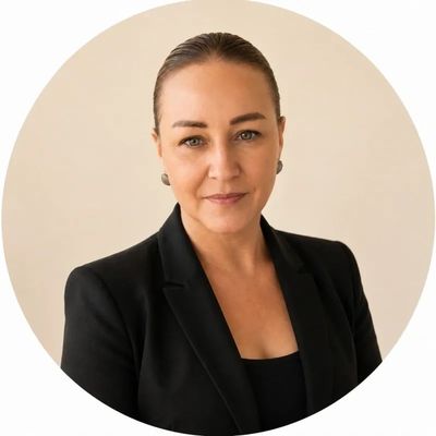 Professional woman in black blazer with confident expression.