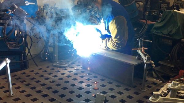 Photo of us flux core welding together a box.