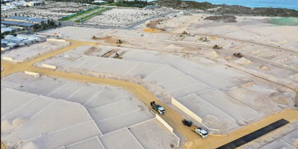 Construction site with earth roads and trucks.