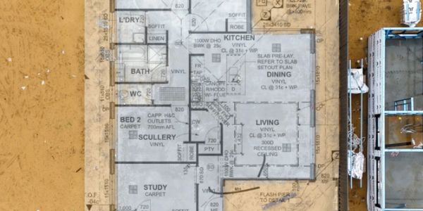 Architectural floor plan overlaid on a construction site.