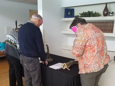 Guests looking at tactile art.