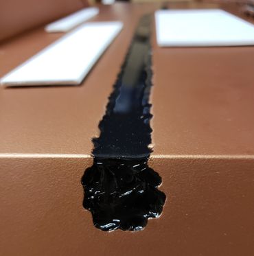 The etch groove painted and filled with black silicone mimicking ink.