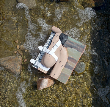 Artistic photo of the finished test piece in a shallow creek with foaming water.