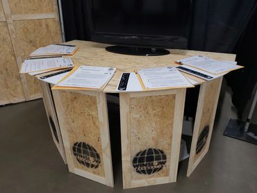 Rounded table with Nocterra information packets on the top.