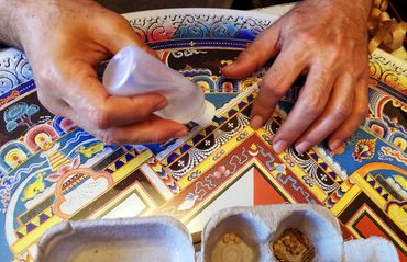 Hands solvent gluing the tiny pieces one by one.