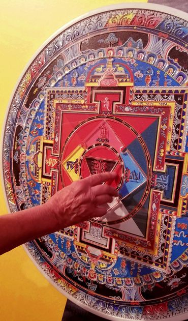 Tactile mandala being touched by someone.