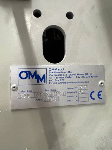 Industrial textile machine spinning white yarn in factory.