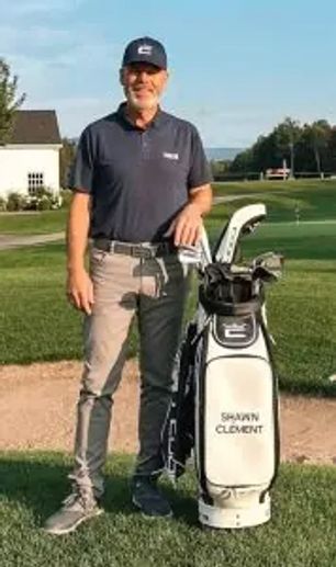 Man stands with golf bag on course in sunny weather.