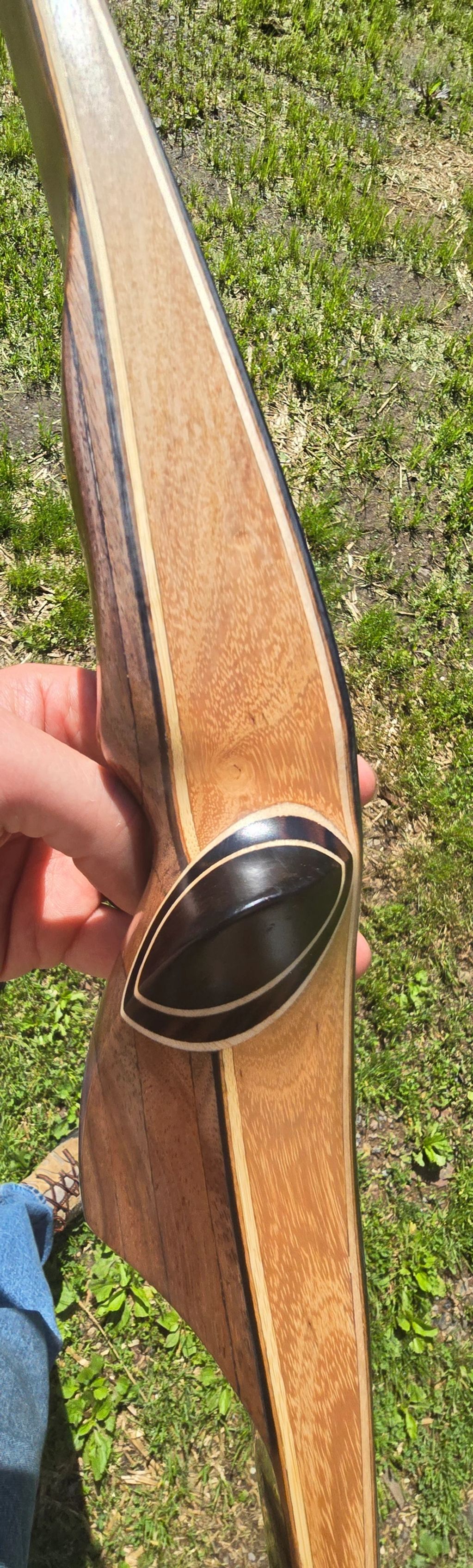 Longbow with a thumb rest