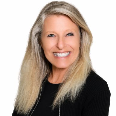 Smiling woman with long blonde hair.