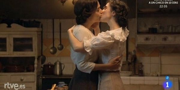 Women in 1900s kissing in kitchen