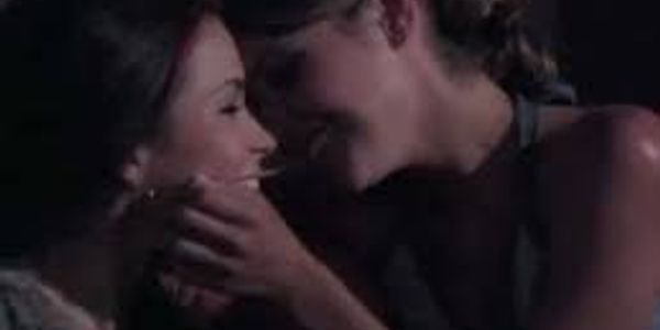 Teenage girls flirting, leaning in for a kiss