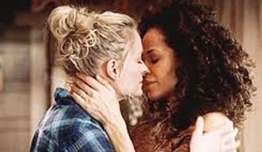 White woman and WOC about to kiss