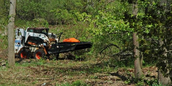 Land clearing with brush mower